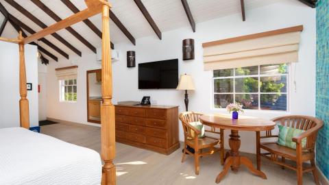 Classic four-poster bed room with wooden furnishings and exposed beams