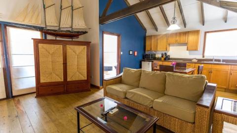 Cozy living room with plush sofa, wooden details, and vibrant walls.