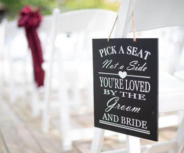 Outdoor wedding sign on chair reading 