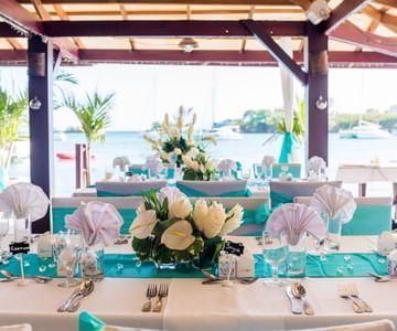 Elegant wedding table setting with turquoise runners and floral decor