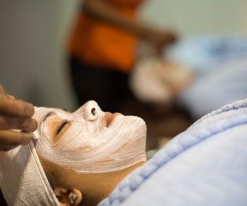 Skincare professional applying facial treatment in spa setting