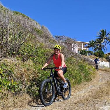 Barbados Adventure with Biking Activities and Scenic Views Person biking in Barbados with landscape in the background