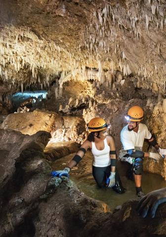 Barbados Adventure: Exploring Underground Caves Cave exploration in Barbados with adventurous people