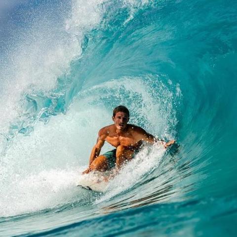 Barbados Adventure with Surfer Riding a Wave Surfer catching a wave in Barbados