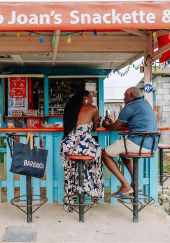 Barbados culture and cuisine at a local snack bar A couple enjoying drinks at a local Barbados snack bar