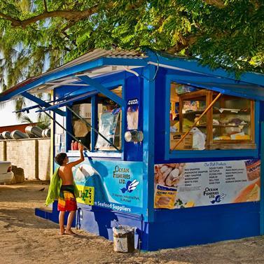Barbados Local Food Stand With Beachgoers Food kiosk in Barbados with local cuisine