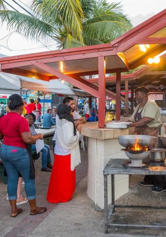 Barbados Culinary Experience with Local Flavors Local food stall interaction in Barbados with chef and visitors