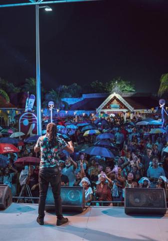 Barbados Music Scene Captured at a Live Event Performer at a music event in Barbados with an engaged crowd