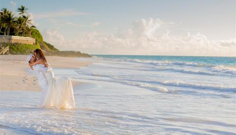 Barbados Beachfront Wedding: A Blissful Celebration Wedding couple embracing on a Barbados beach at sunset