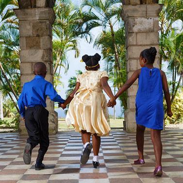 Barbados Cultural Moment with Children Children in cultural attire walking hand in hand in Barbados