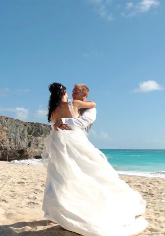 Barbados Nuptial Bliss: A Beachside Wedding Celebration Wedding couple embracing on a Barbados beach