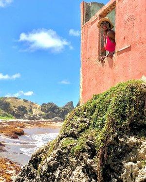 Barbados Exploration - A Glimpse of Coastal Beauty and Culture Person looking out from a coastal structure in Barbados