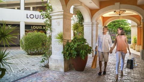 Barbados shopping experience with joyful patrons Shoppers walking through an upscale outdoor shopping area