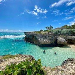 Barbados Scenic Beach View with People Enjoying the Water Beachgoers swimming in bright blue waters off Barbados coast