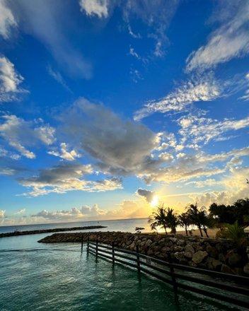 Barbados: A Breathtaking Sunset View by the Beach Scenic sunset over a Barbados beach with calm waters