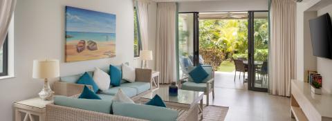 This image depicts a bright and airy living room in a modern beach house style