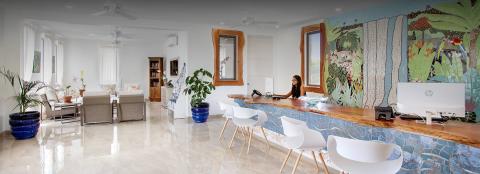 This image showcases a spacious, elegantly designed interior space featuring a blend of living and work areas
