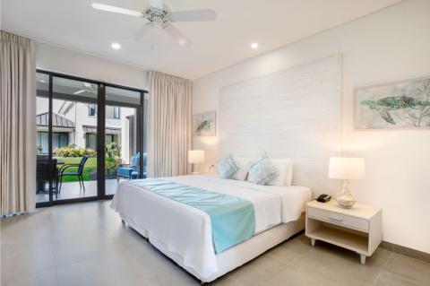 This image shows a neatly arranged bedroom featuring a modern clean design