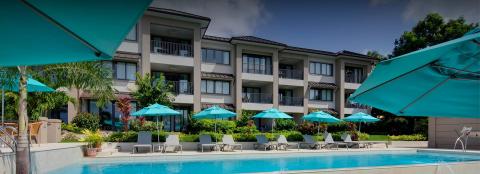 This image shows a serene hotel or resort pool area
