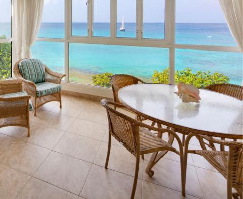 This image shows a cozy, seaside room with a fantastic ocean view