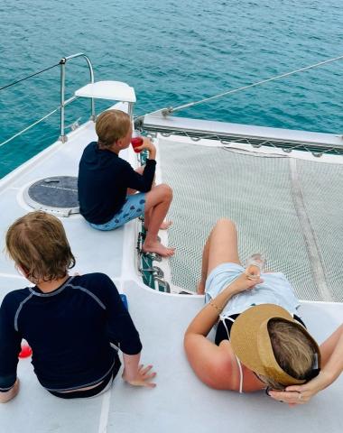 This image depicts a family enjoying time on a boat