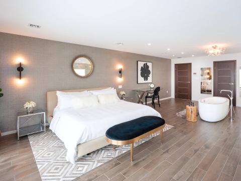 This is an image of a spacious and elegantly furnished bedroom