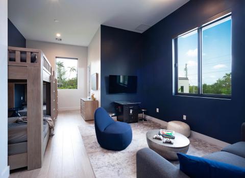The image shows a modern room designed with a blend of practical and leisure elements