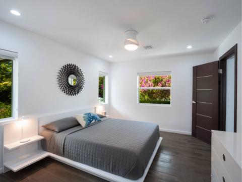 This image shows a modern bedroom with a minimalist design