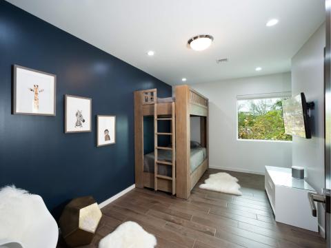 This image shows a well-appointed, modern bedroom with a youthful and sophisticated decor
