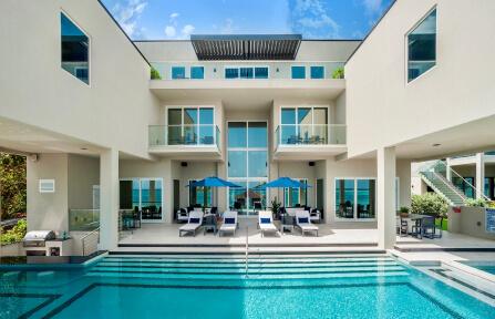 This image features a luxurious modern home with a swimming pool