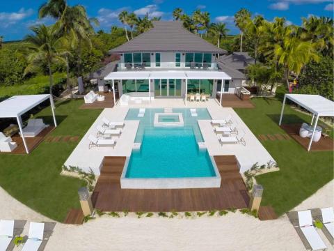 This image showcases a luxurious beachfront property with a modern design