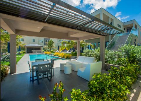 This image showcases an elegant outdoor living space adjacent to a modern residential building