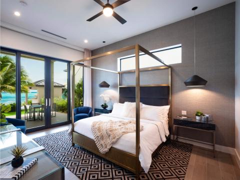 This image showcases a luxurious and modern bedroom that opens to a beautiful outdoor view