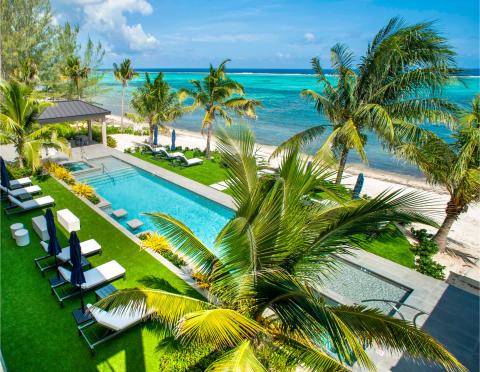 This image features a luxurious beachside setting with various elements designed for relaxation and enjoyment