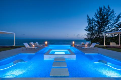 This image features a serene and luxurious outdoor setting at twilight