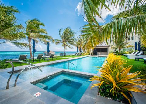 This image shows a luxurious pool area by the sea
