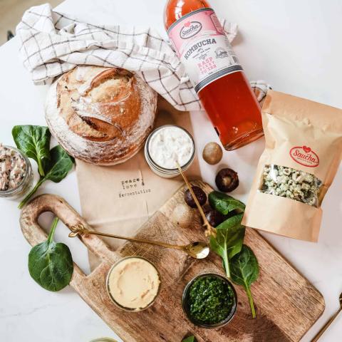 The image displays a variety of food items and a beverage arranged aesthetically on a white surface