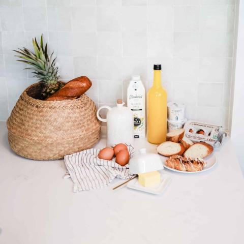 This image showcases a variety of food items and drinks arranged on a kitchen countertop