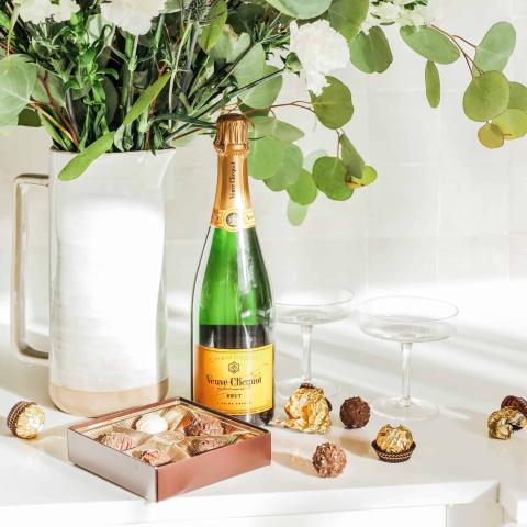 The image features a stylish and luxurious setting with various items arranged meticulously on a surface
