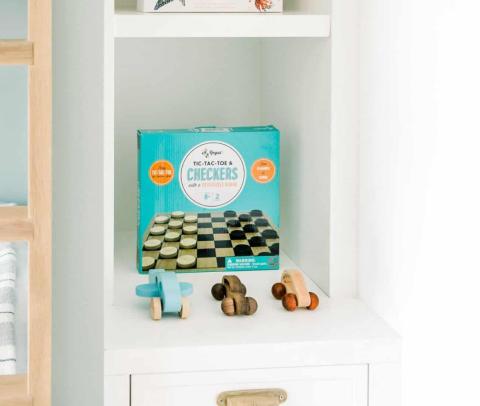 The image shows a shelf in a white cabinet neatly storing an assortment of items