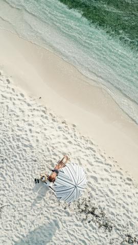 This image shows a beautiful beach scene captured from an aerial perspective