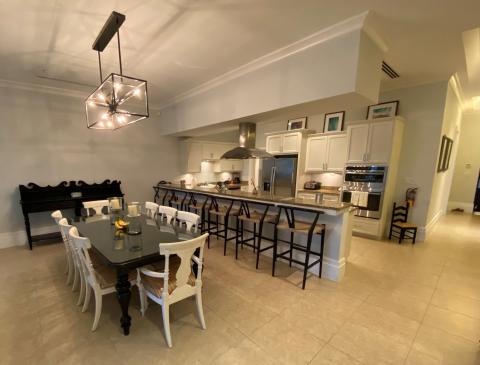 The image shows a well-appointed kitchen and dining area