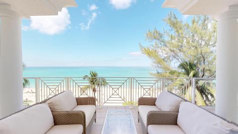 This image shows a beautiful beachfront view from a balcony