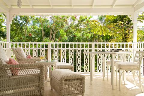 This image shows a tranquil and inviting outdoor porch area