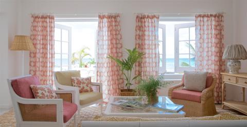 This image depicts a bright and airy beach house living room