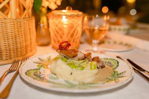 This image features a beautifully plated meal, likely taken at an elegant dining setting