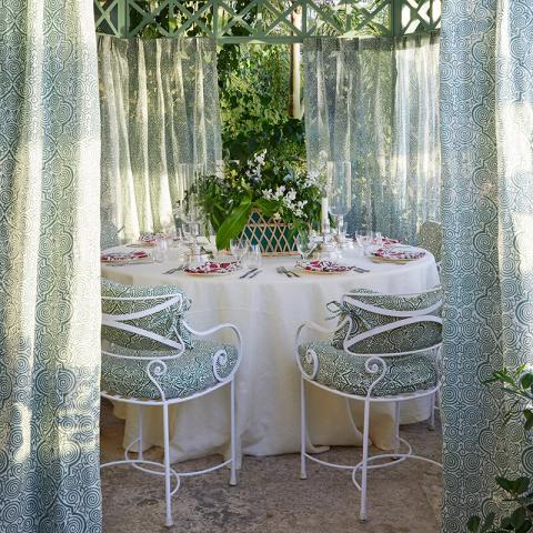 The image depicts a beautifully arranged garden dining setup