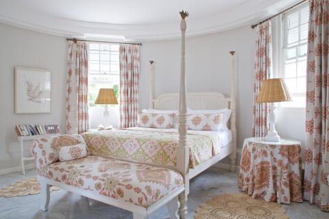 The image shows a brightly lit and elegantly decorated bedroom