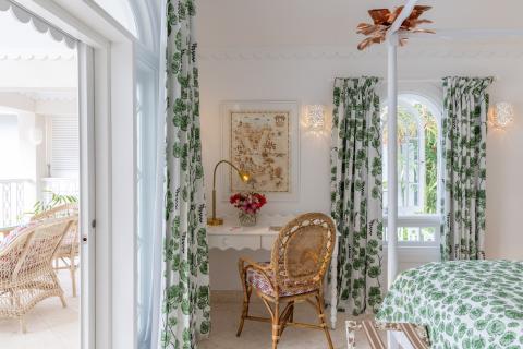 The image shows a charming and bright bedroom adorned with botanical-themed decor