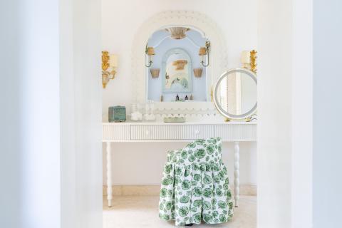 This image shows a beautifully designed and decorated bathroom or vanity room featuring a serene white and light-blue color scheme